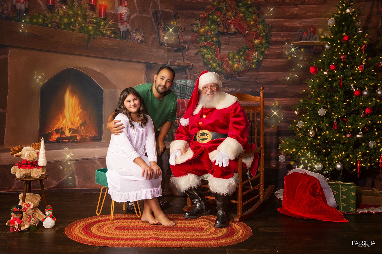 Father and daughter with Santa in a cozy seting with fireplace and Christmas tree in the background